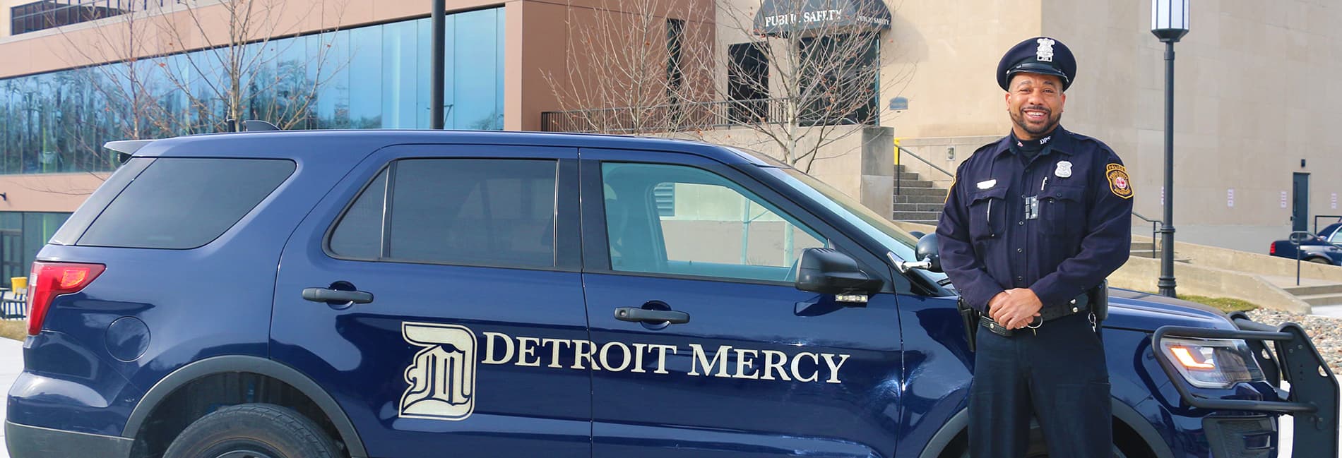 detroit mercy public safety officer by his vehicle