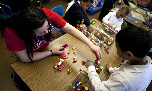 student playing legos with child