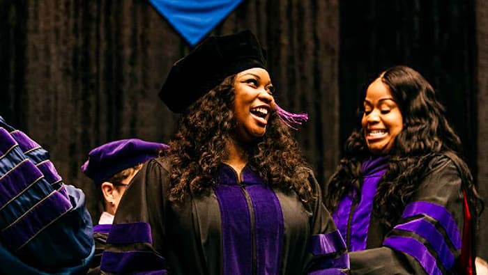 two female students in commencement gowns