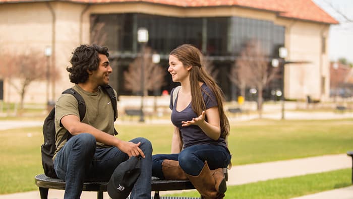 two students talking outside